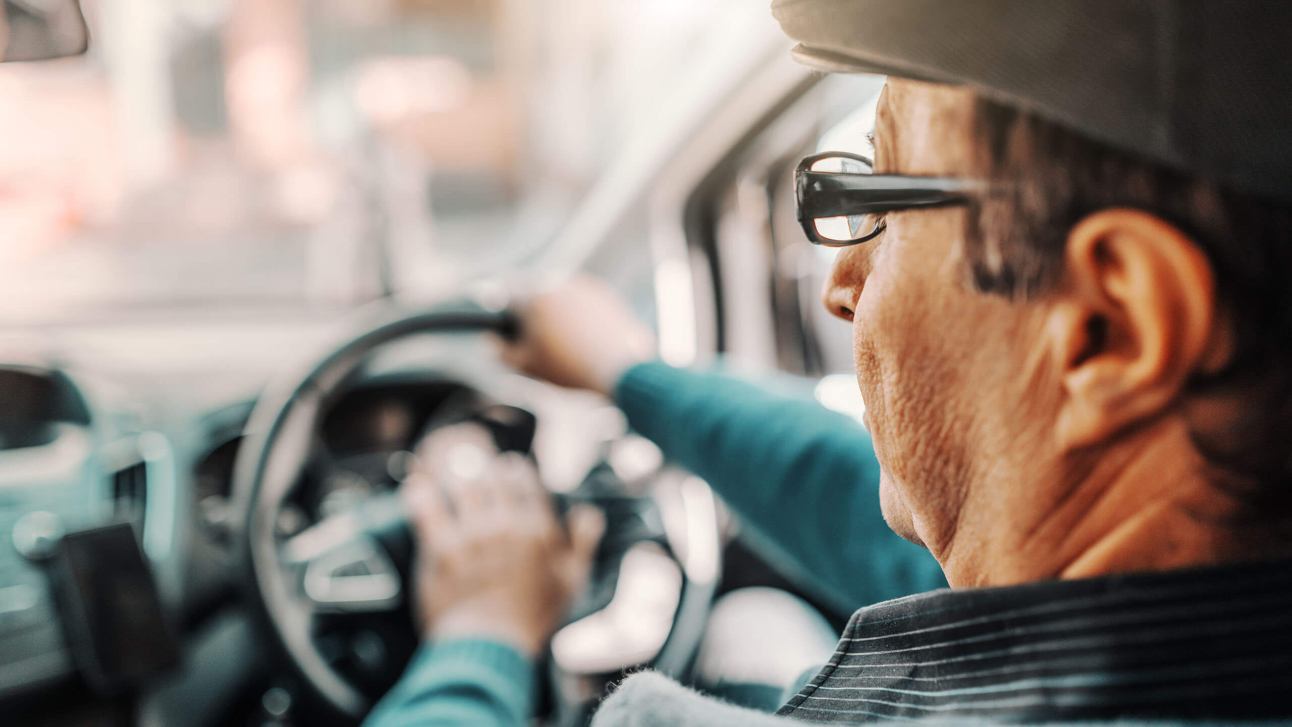 Kaihi-ikäinen mies auton ratissa